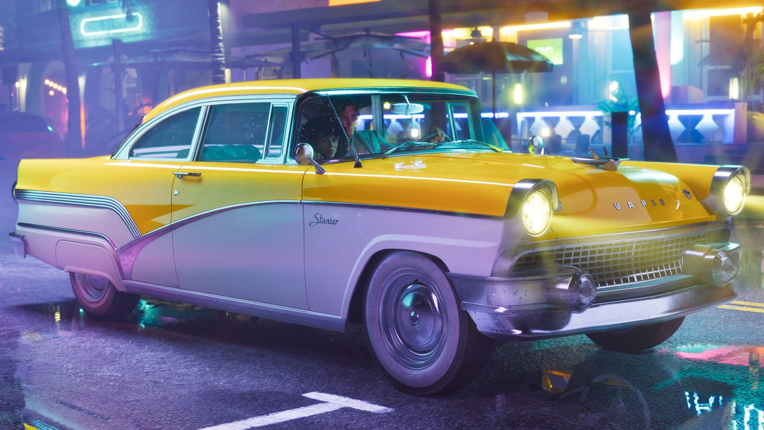The ’55 Vapid Stanier, a two-tone classic, on a neon street at night.